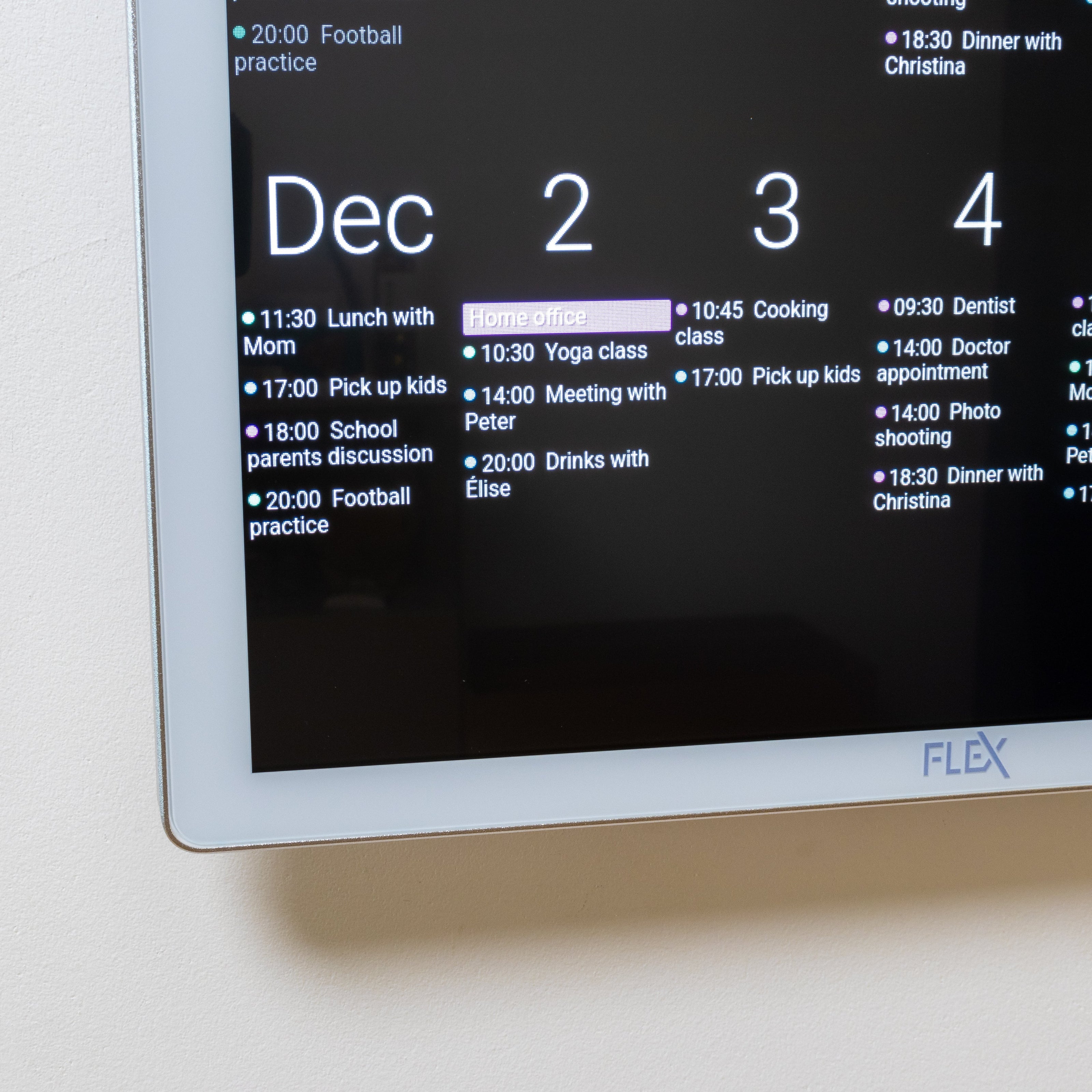 Digital calendar on a wall displaying a schedule with the brand 'Flex' visible.
